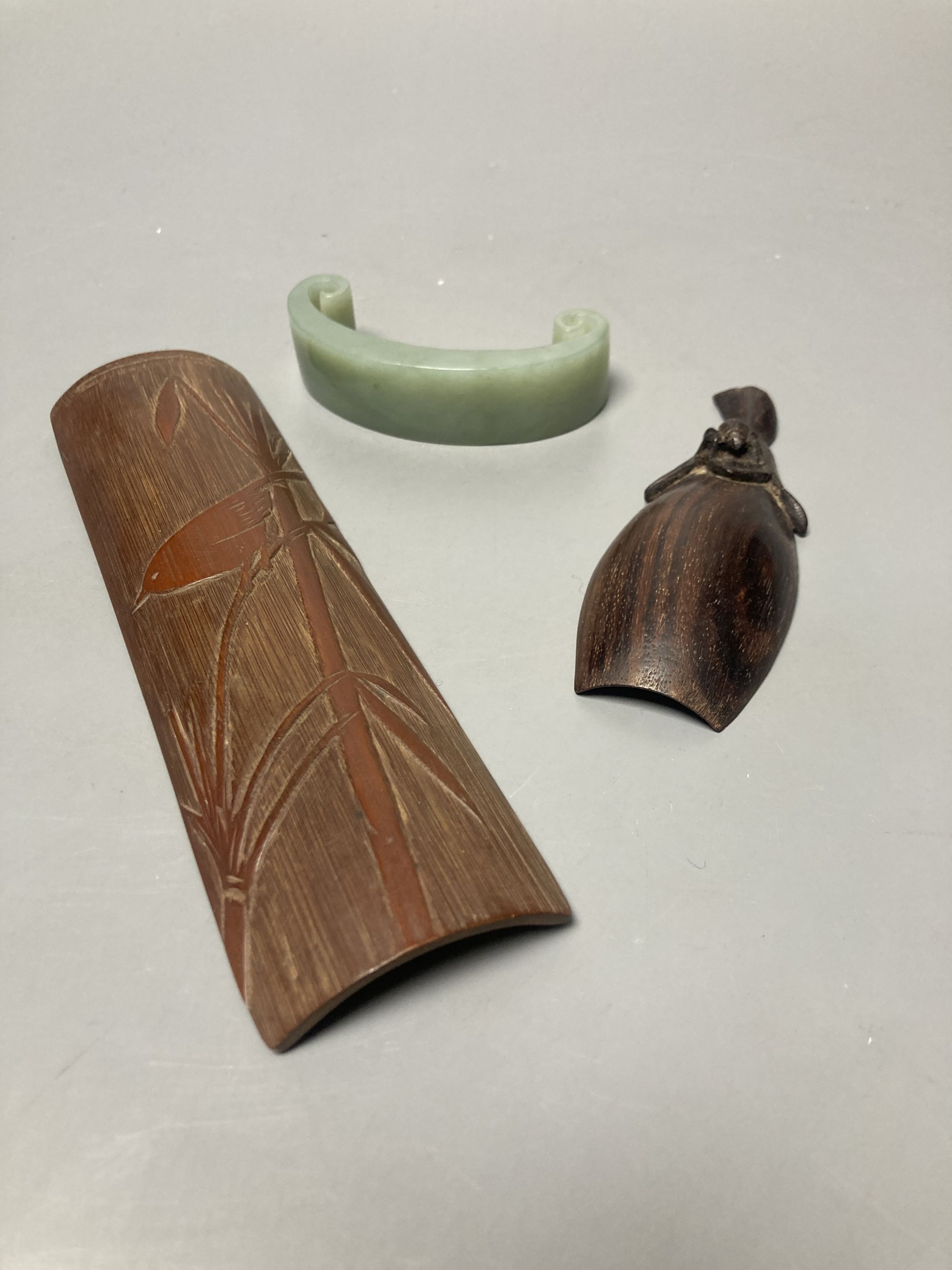 A Japanese bamboo wrist wrest, a Chinese jadeite, bamboo scoop and wooden carving possibly Zitan, 19th century etc.
